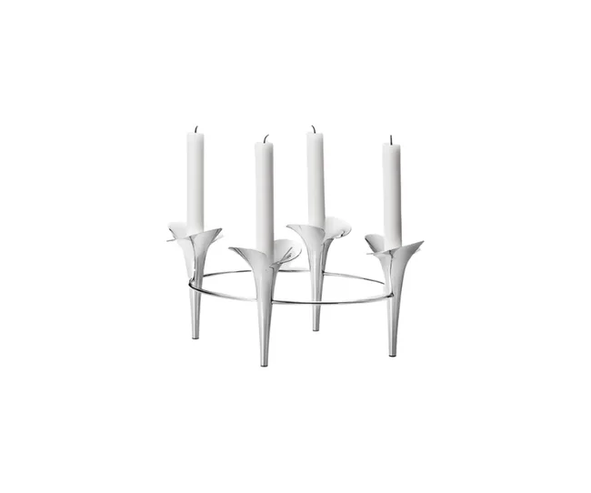 A silver candleholder with four tall white candles, each resting in a conical stand, resembling flower petals.