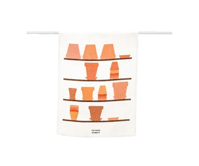 Tea towel with illustrated terracotta pots on shelves, labeled "Father Rabbit."