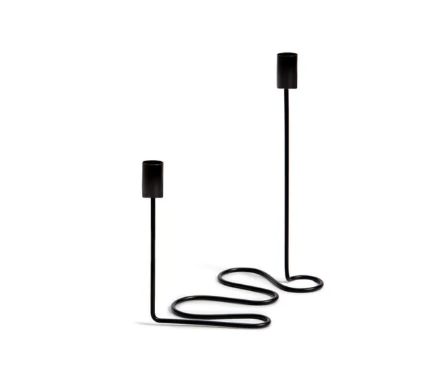 Two modern black metal candlesticks with wavy bases on a white background.