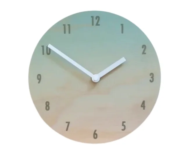 Round clock with gradient background showing 10:10. White hour and minute hands, black numerals.