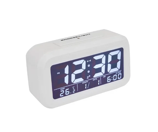 Digital alarm clock displaying 12:30, with temperature, date, and alarm set for 6:00 AM on a white casing.