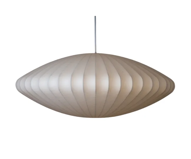 Mid-century modern oval pendant lamp with ribbed white finish, hanging from a thin cord.