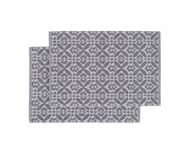 Gray and white geometric patterned cloth placemats overlapping each other on a white background.