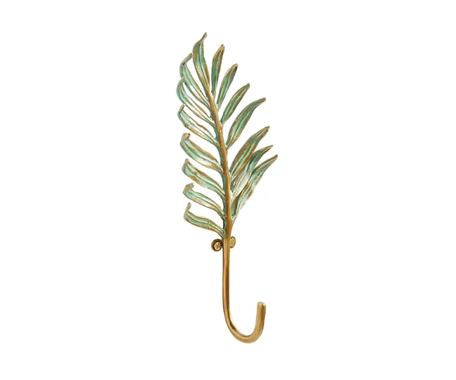 Golden wall hook shaped like a palm leaf with green accents.