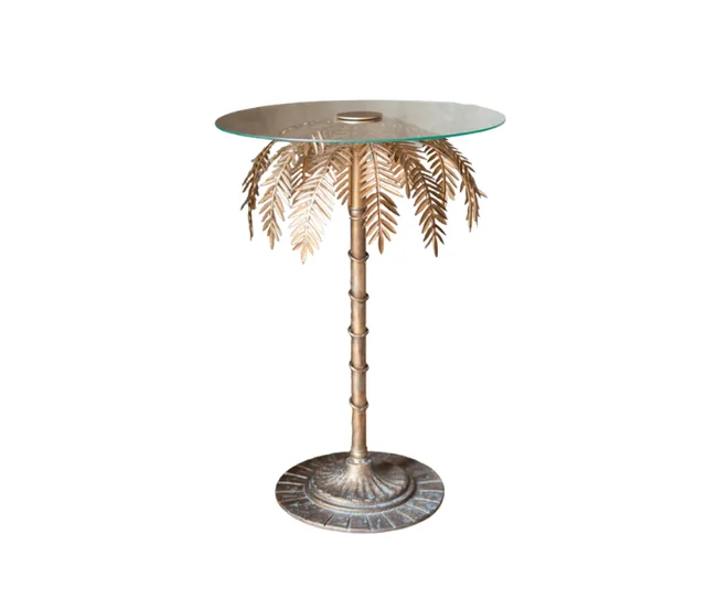 Side table with glass top and gold palm leaf design on a single column stand.