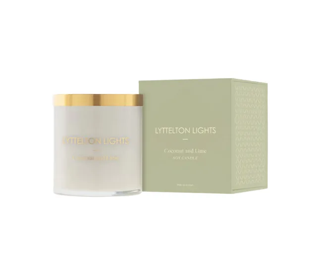 Lyttelton Lights Coconut and Lime soy candle with a gold lid, next to its green packaging box.