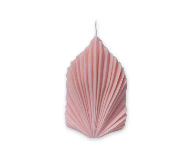 A pink, leaf-shaped candle with ribbed texture against a white background.