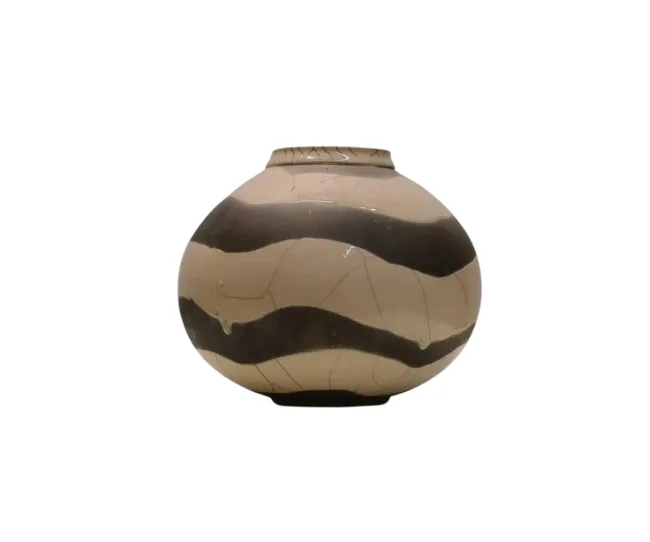 Ceramic pot with a rounded shape and alternating black and beige wavy stripes on the surface.