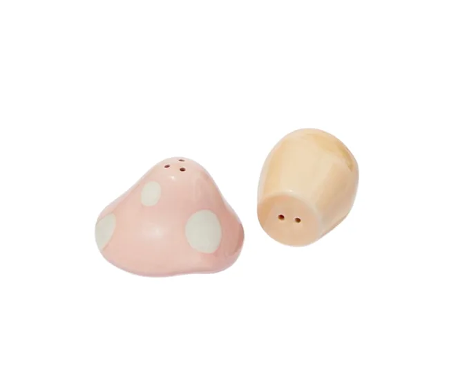 Pink and tan ceramic salt and pepper shakers shaped like abstract mushrooms on a white background.