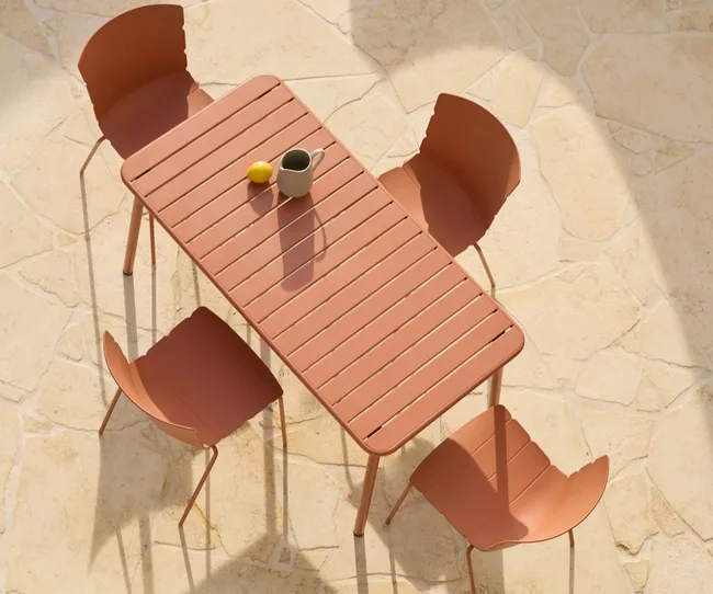 Peach coloured dining table and four dining chairs