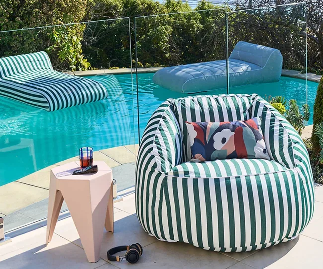Bean bag chair next to a pool