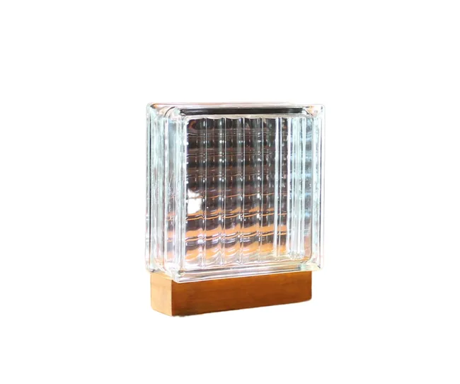 Glass block table lamp with LED light on a wooden base, isolated on a white background.