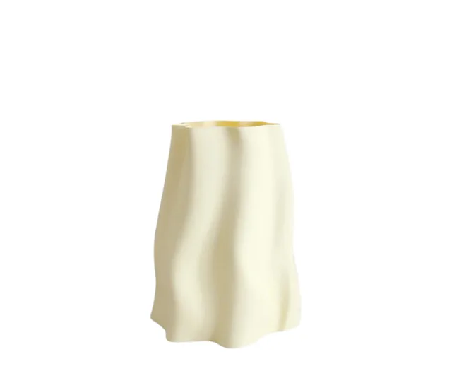 A wavy cream-colored ceramic vase with a minimalist design on a white background.