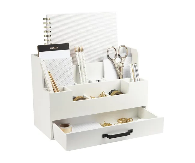 White desk organizer with drawers holding notebooks, scissors, pens, and various office supplies.
