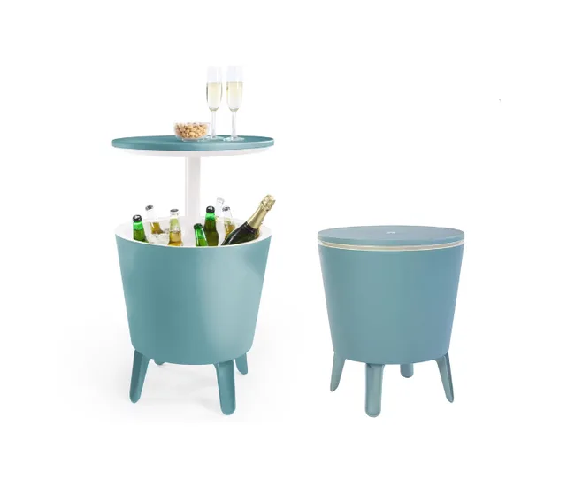 A teal cooler table with drinks and champagne glasses on top, next to a closed table.