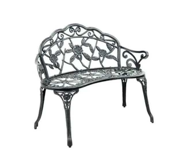 Ornate metal garden bench with rose design on backrest and curved seat.