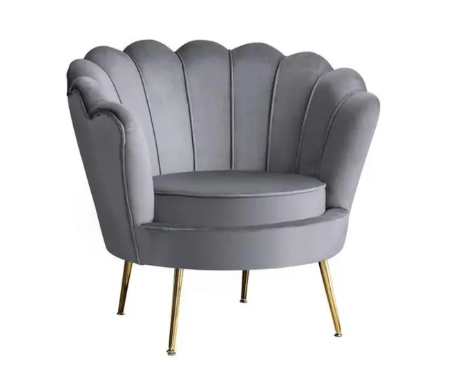 Grey velvet scallop-shaped armchair with gold legs.