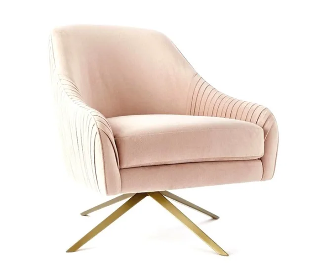 Pink velvet swivel chair with pleated sides and gold metal legs.