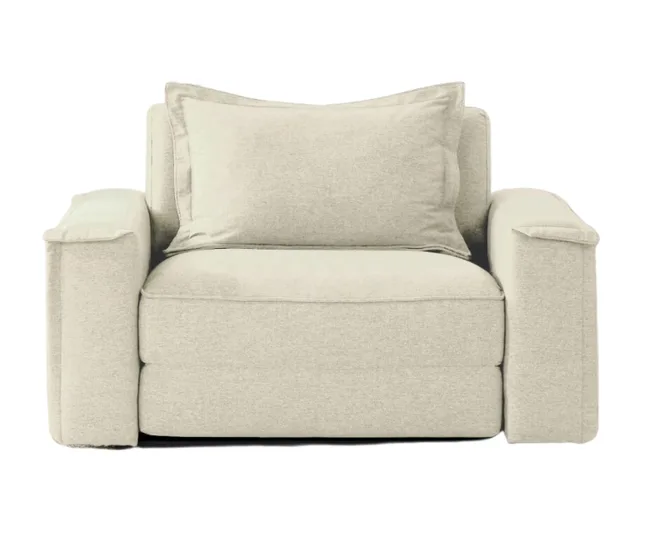 Cream-colored, plush armchair with thick cushions and wide armrests, viewed from the front.