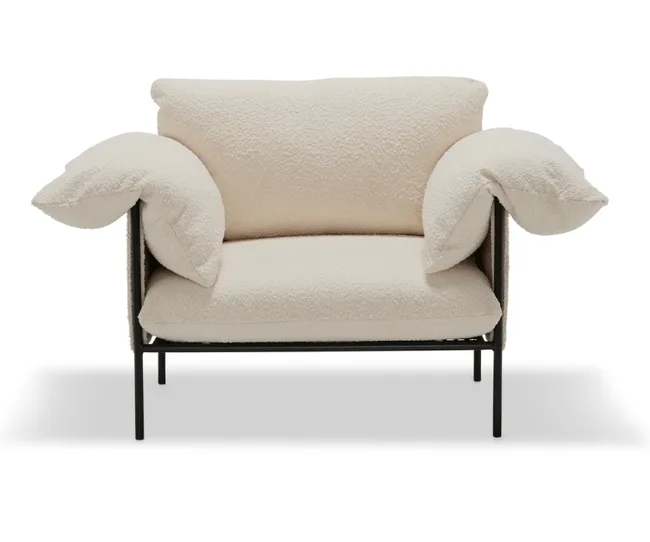 Cream armchair with soft, plush cushions and metal frame, viewed from the front.