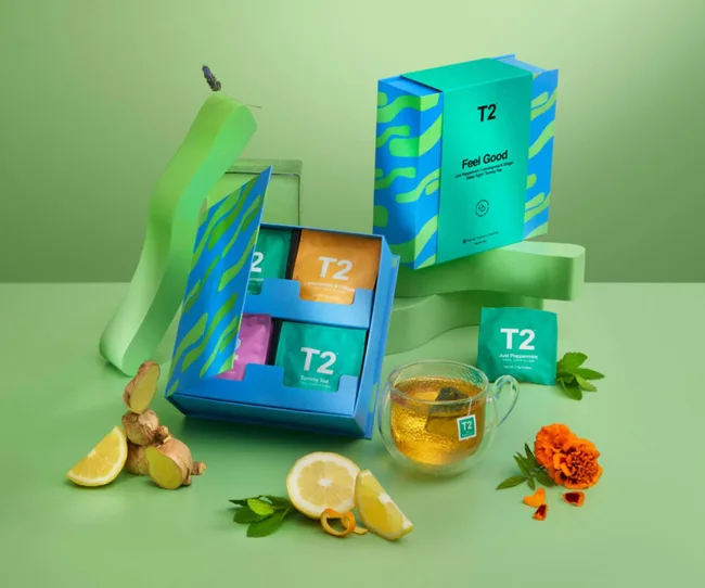 A collection of T2 teas in a blue and green gift set, against a green background