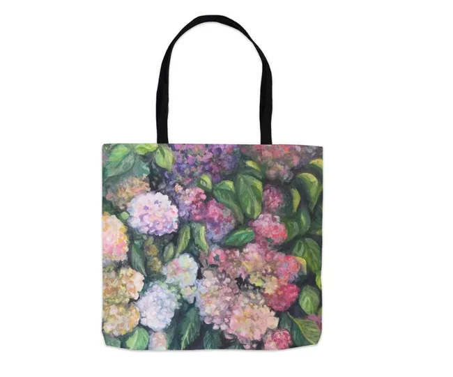 Tote bag featuring a colorful hydrangea design with pink, purple, and green hues.