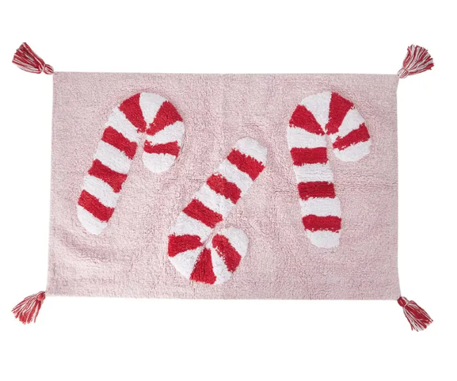 Pink rug with three red and white striped candy canes and tassels at each corner.