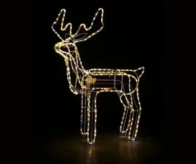 A wireframe reindeer covered in glowing lights against a dark background.