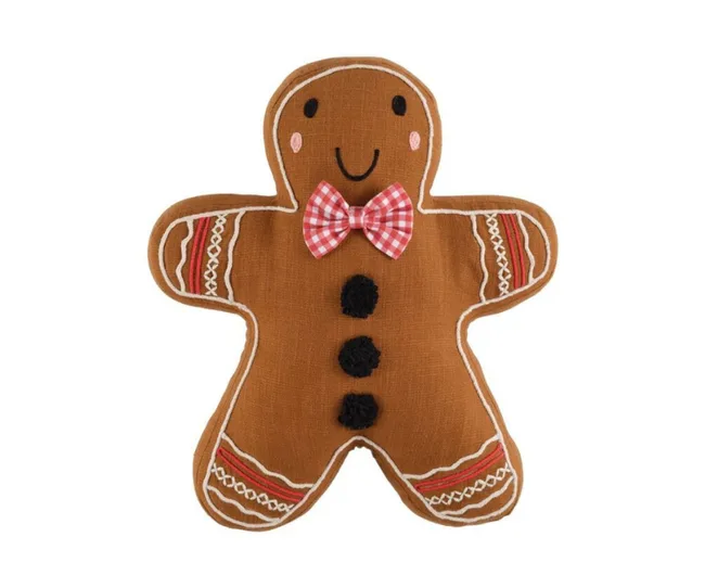 Gingerbread man pillow with a red checkered bow tie, black buttons, and a stitched smile on a white background.