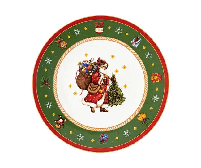 Ceramic plate with Santa carrying gifts and a tree, surrounded by Christmas decorations on a green border.