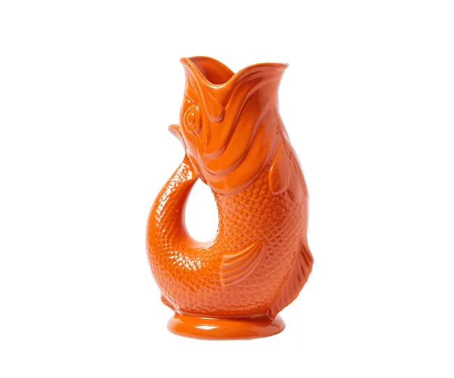 Orange ceramic jug shaped like a fish, with a wide open mouth and textured scales.