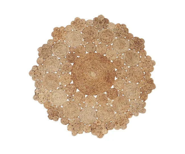 A round, intricately woven jute rug with a pattern of concentric circles, displaying a natural beige color.