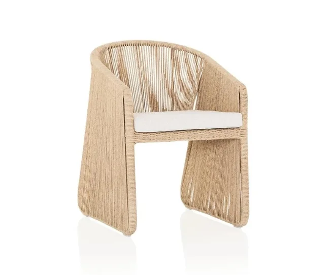 Tan wicker chair with white cushion, featuring a contemporary angular design and open weave pattern.