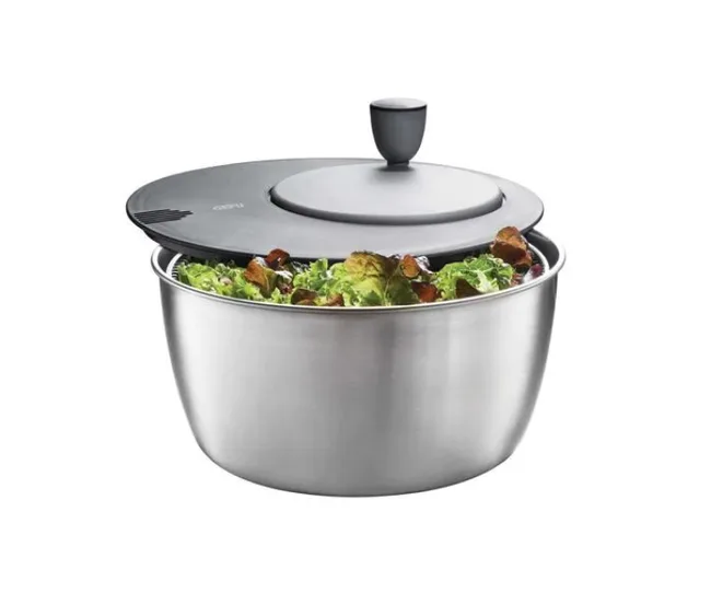 Stainless steel salad spinner with black lid and lettuce inside.