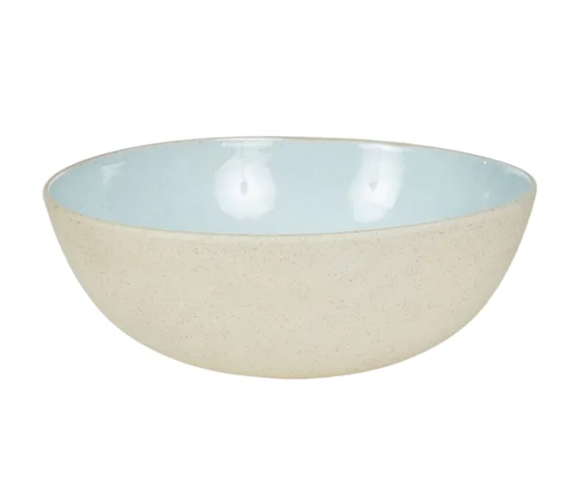 A ceramic bowl with a light beige exterior and a pale blue interior on a white background.