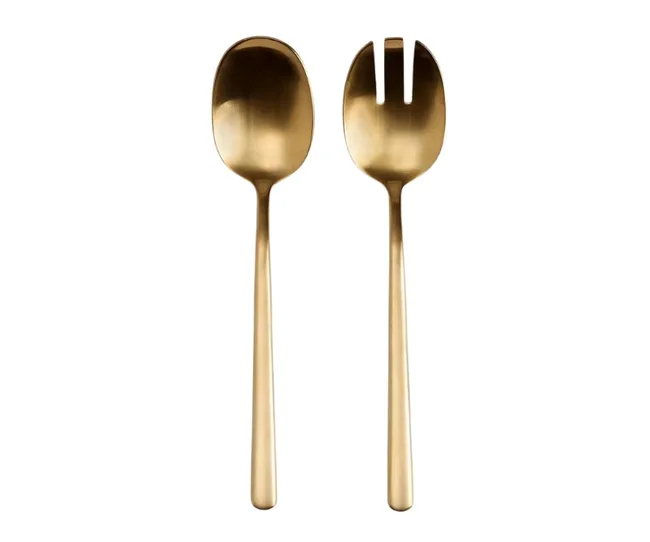 Gold serving spoon and spork on a white background.