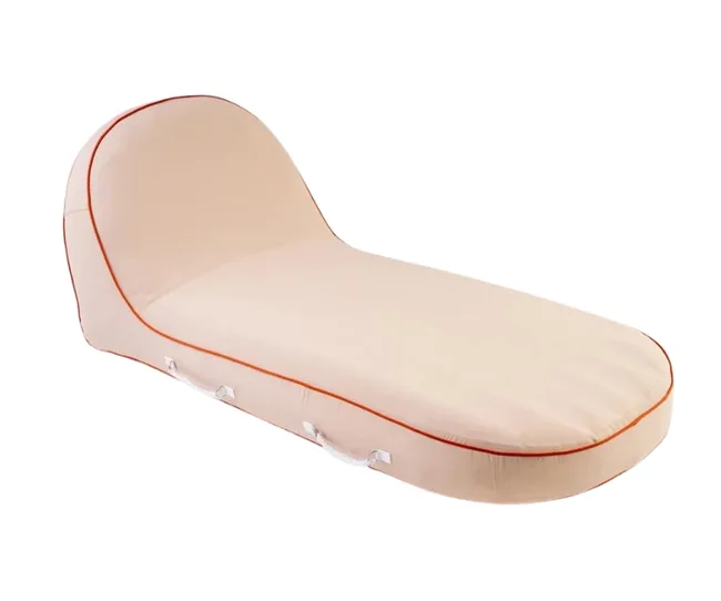 Beige, wedge-shaped lounging cushion with orange piping and side handles, designed for comfort or support.