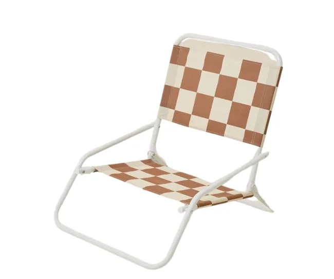 Foldable chair with white metal frame and brown checkered fabric seat and backrest.