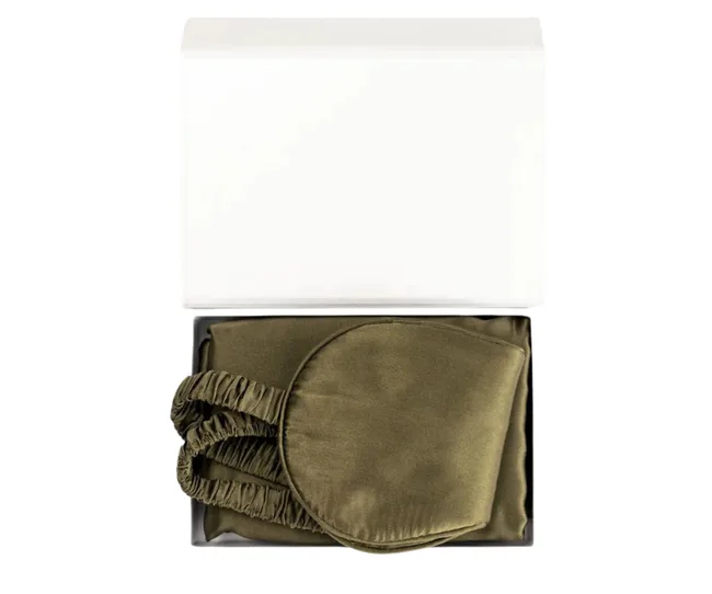 Olive green silk eye mask set in an open box with white lid.
