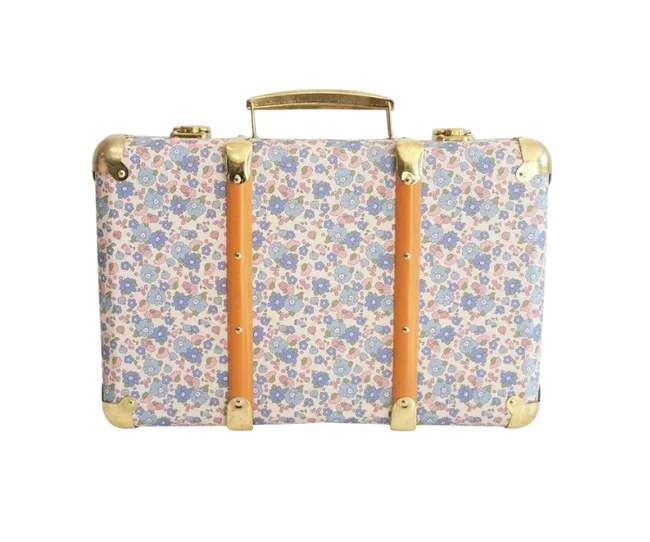 Vintage floral suitcase with brass corners and leather straps.