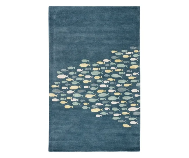 A navy blue nursery decor rug with a school of blue and grey fish in the middle