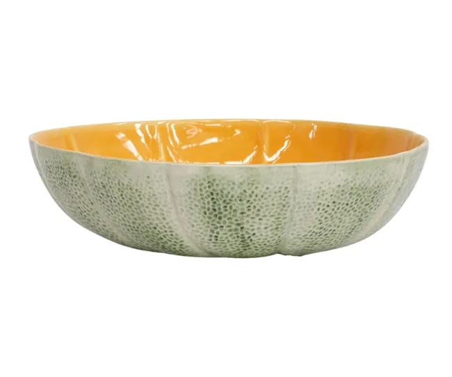 Ceramic bowl with a textured green exterior and smooth orange interior resembling a cantaloupe.
