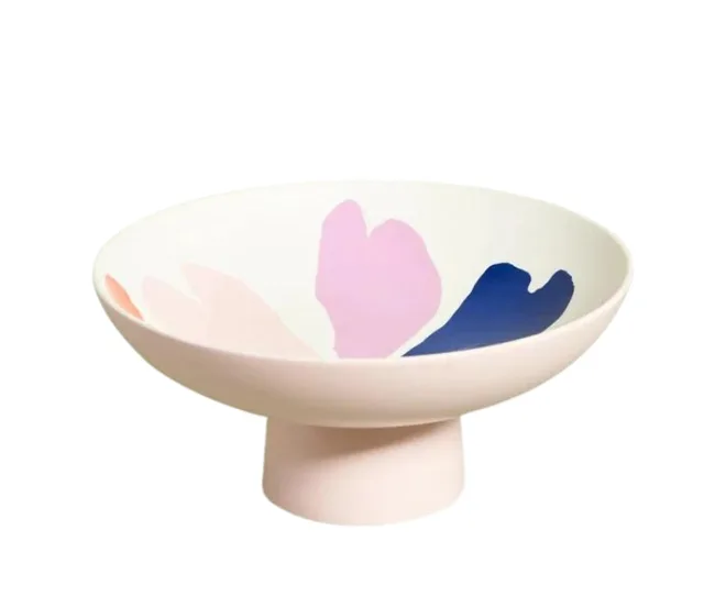 Ceramic bowl with pink and navy abstract shapes on a pedestal base.