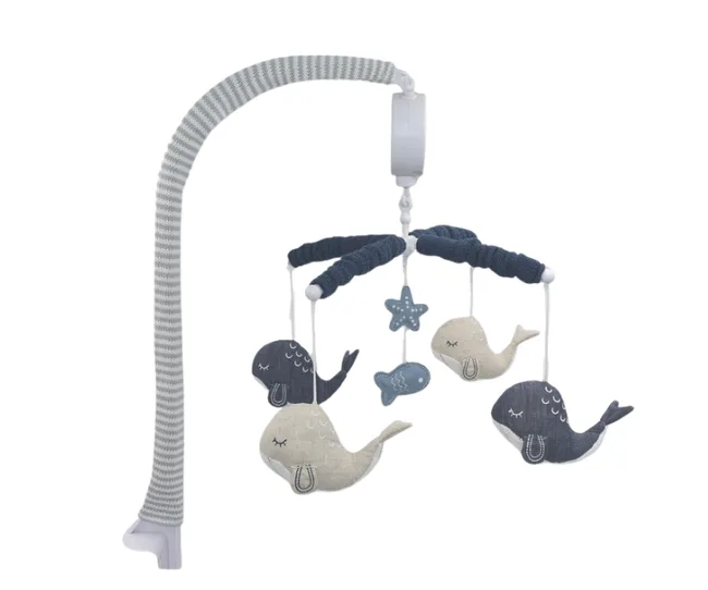 Baby mobile with gray and blue whale plush toys hanging, attached to flexible arm for crib.