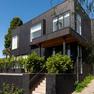 This stunning black house perfectly suits every season