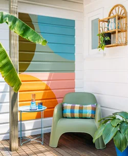Outdoor mural in blue, grey, green, orange and pink
