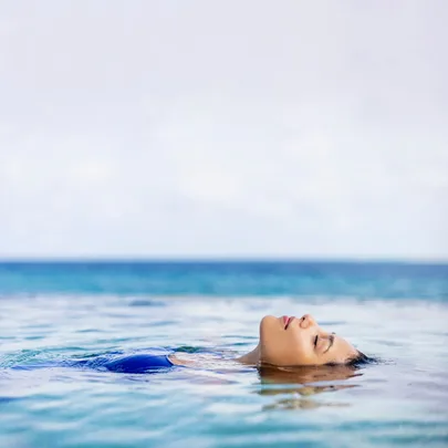 Woman floating on her back in a body of water