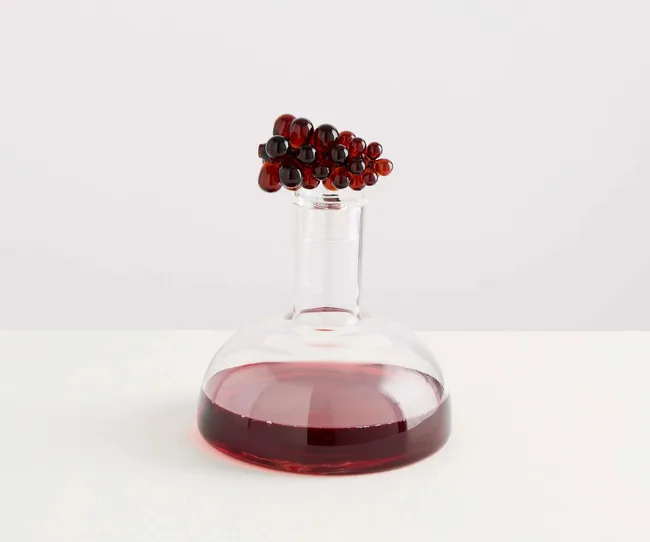 A wine decanter filled with red wine
