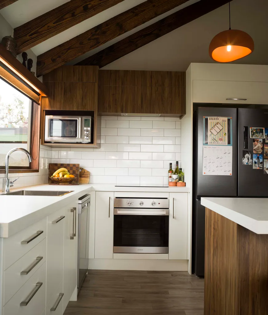 A white kitchen with wooden cupboards overhead