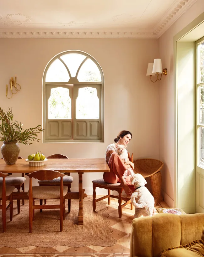 The homeowner with her dogs sitting at her dining room table